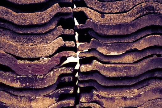 A pile of house tiles arranged parallel to each other. photo