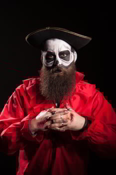 Man dressed up like a dangerous pirate for halloween over black background. photo