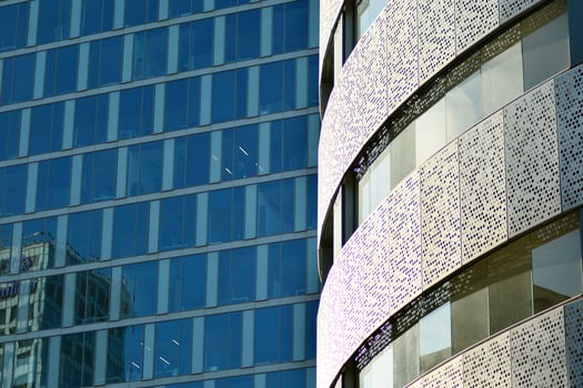 Glass building with transparent facade of the building and blue sky. Structural glass wall reflecting blue sky. Abstract modern architecture fragment. Contemporary architectural background. photo