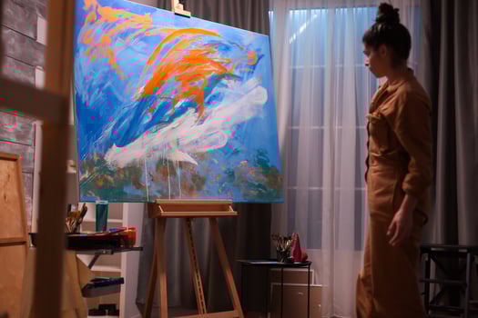 Artist woman checking her abstract painting in art workshop. Modern artwork paint on canvas, creative, contemporary and successful fine art artist drawing masterpiece photo