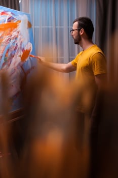 Creative man painting on canvas in art studio. Modern artwork paint on canvas, creative, contemporary and successful fine art artist drawing masterpiece photo