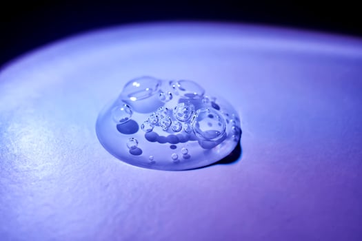 A drop of serum under ultraviolet light. photo