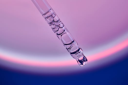 Pipette with serum in a space atmosphere. photo