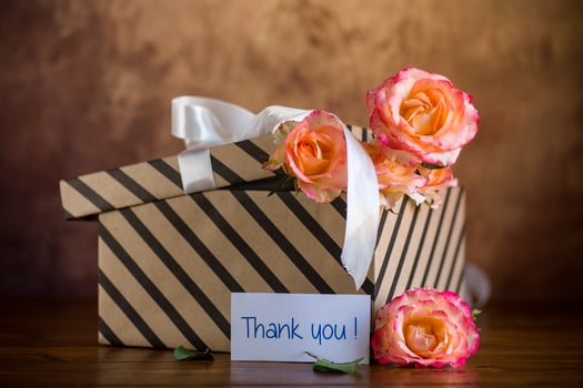 gift box with ribbons and beautiful roses inside. photo