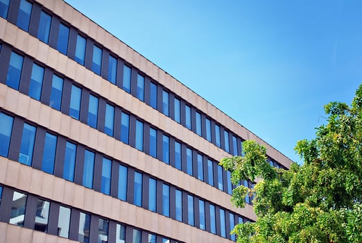 Modern office building in the city with windows and  steel and aluminum panels wall. Contemporary commercial architecture, vertical converging geometric lines. photo