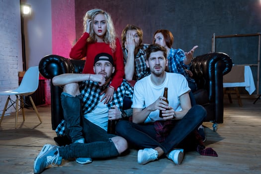 Group of friends watching TV match at home photo