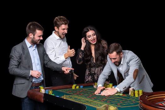 Upper class friends gambling in a casino. photo