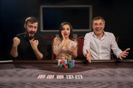 Group of a young rich friends are playing poker in casino. photo