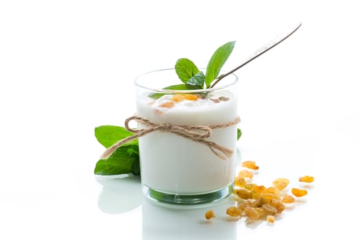 sweet homemade yogurt with raisins in a glass photo