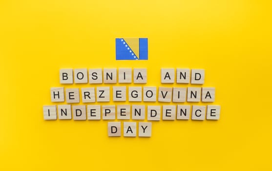 On March 1, Independence Day of Bosnia and Herzegovina, a minimalistic banner with an inscription in wooden letters on an orange background photo