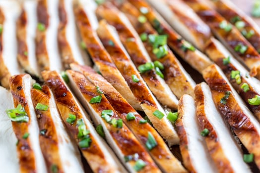 Slices of grilled chicken in lime sauce photo
