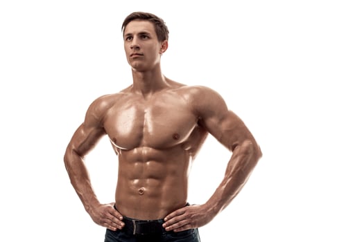 Muscular handsome young man with naked torso. Isolated on white background. photo