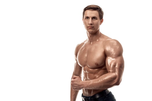 Muscular handsome young man with naked torso. Isolated on white background. Copy space photo