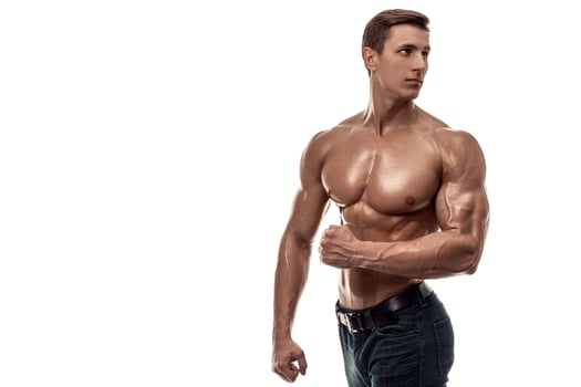 Muscular handsome young man with naked torso. Isolated on white background. Copy space photo