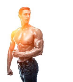 Muscular handsome young man with naked torso. Isolated on white photo