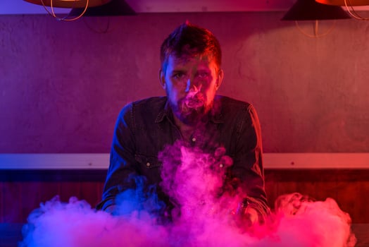 The man smoke an electronic cigarette at the vape shop. photo