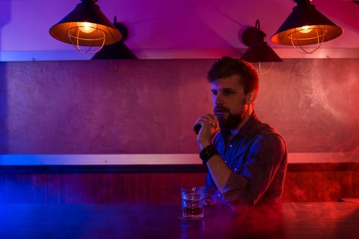 The man smoke an electronic cigarette at the vape shop. photo
