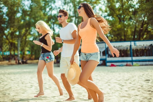 Young funny guys in sunglasses on the beach. Friends together. photo
