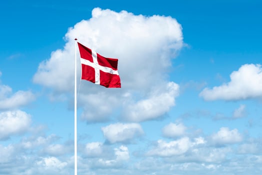 Flag of Denmark against blue sky photo