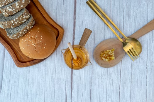Breakfast set Honey in a measuring cup with bread and milk photo
