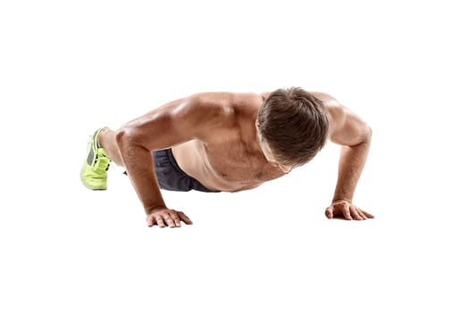 Push up fitness man doing push-up bodyweight exercise on gym floor. Athlete working out chest muscles strength training indoors photo