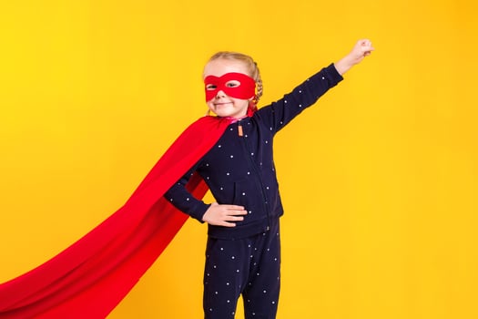Superhero little girl in a red raincoat and a mask photo