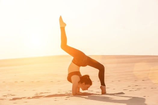 Side view of girl doing squats on grey background photo