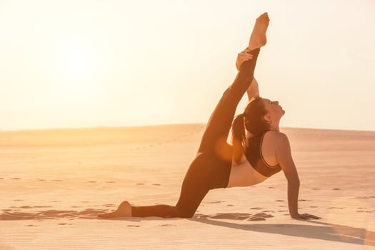 Side view of girl doing squats on grey background photo