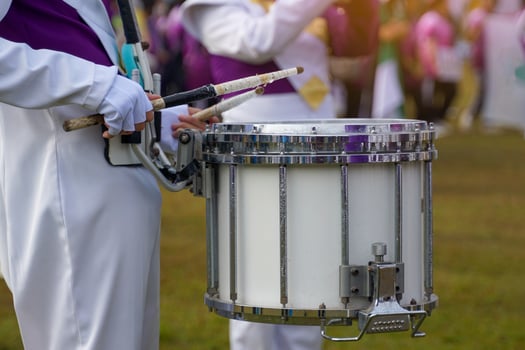Some blurry images of Asian students playing drums during a parade practice. Soft and selective focus. photo