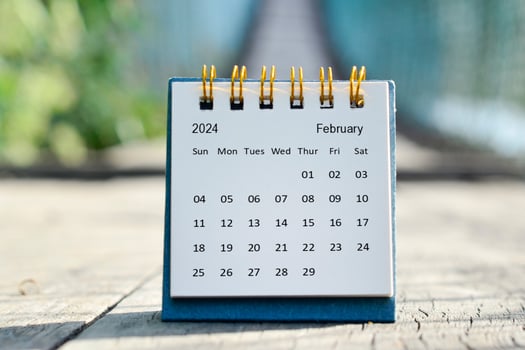 February 2024 white calendar with green blurred background. New year concept. photo