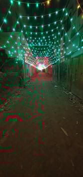 a street with green lights and a tunnel photo