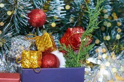 Christmas composition with Christmas tree branches, red tinsel, gift boxes and silver tinsel photo
