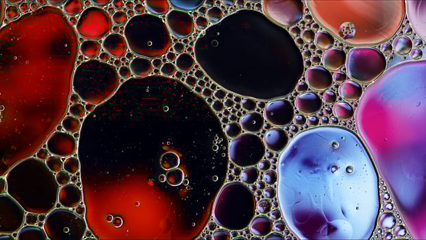 Abstract Colorful Food Oil Drops Bubbles and spheres Flowing on Water Surface photo