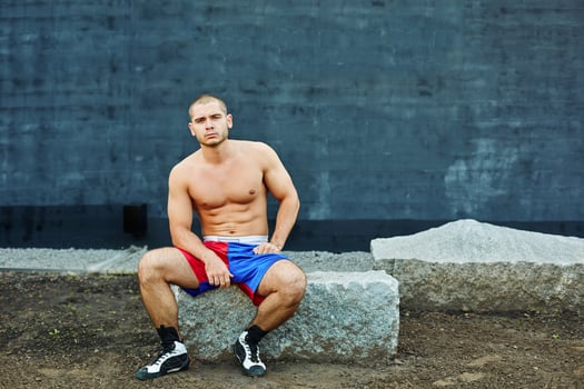 The sportsman has a rest, sitting on rock photo