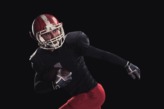 Football player on dark background photo