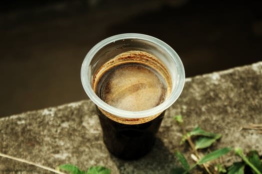 Black coffee served in a plastic cup to start the day. photo