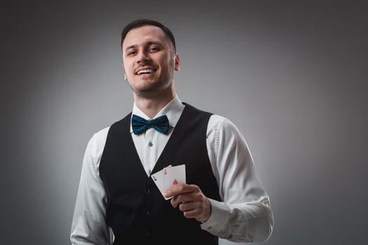 Handsome poker player with two aces in his hands photo