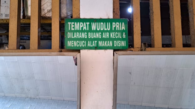 notice board for men's ablutions, prohibition of urination and prohibition of washing eating utensils photo