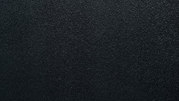 Seamless surface of black sponge foam as background, ethylene vinyl acetate sheet, sandpaper-like fine texture. photo