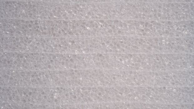 top view of white foam sheet Small and large clear foam beads It is tough, not easy to tear. Polystyrene sheet surface close-up close-up background photo
