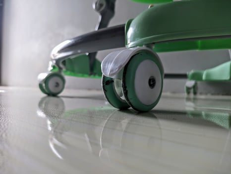 green baby carriage wheels on the floor photo