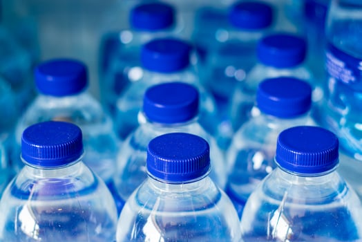 Mineral water bottles in a row with blue caps photo