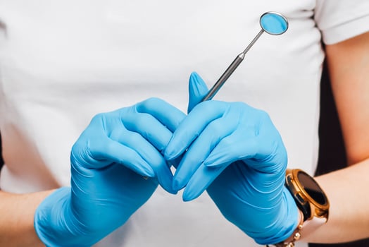 Dental mirror for the oral cavity in the hands of a surgeon. photo