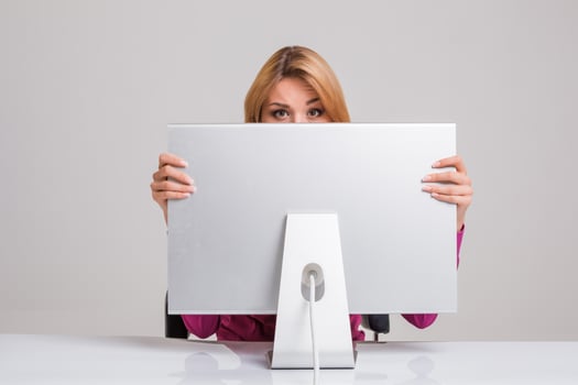 young woman sitting in the table and using computer photo