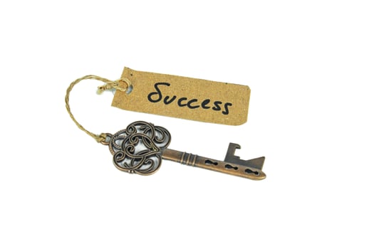 Key to Success concept - Old key with success tag isolated on white background photo
