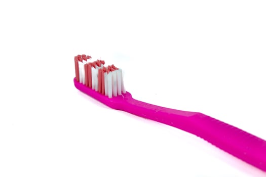 Pink toothbrush on white background photo