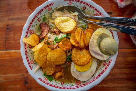 Indonesian Chicken soup or Soto Ayam  is a traditional Indonesian food with a yellowish gravy. photo