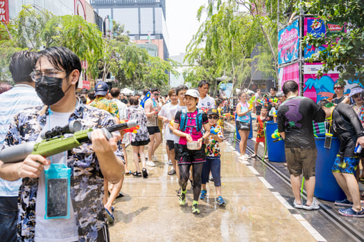 Siam Square, Bangkok, Thailand - APR 13, 2023 Songkran Festival, The short action of people joins celebrations of the Thai New Year or Songkran in Siam Square Bangkok, Thailand. photo