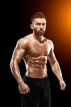 Muscular bodybuilder guy doing posing photo