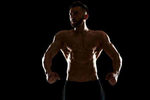 Muscular bodybuilder guy doing posing photo